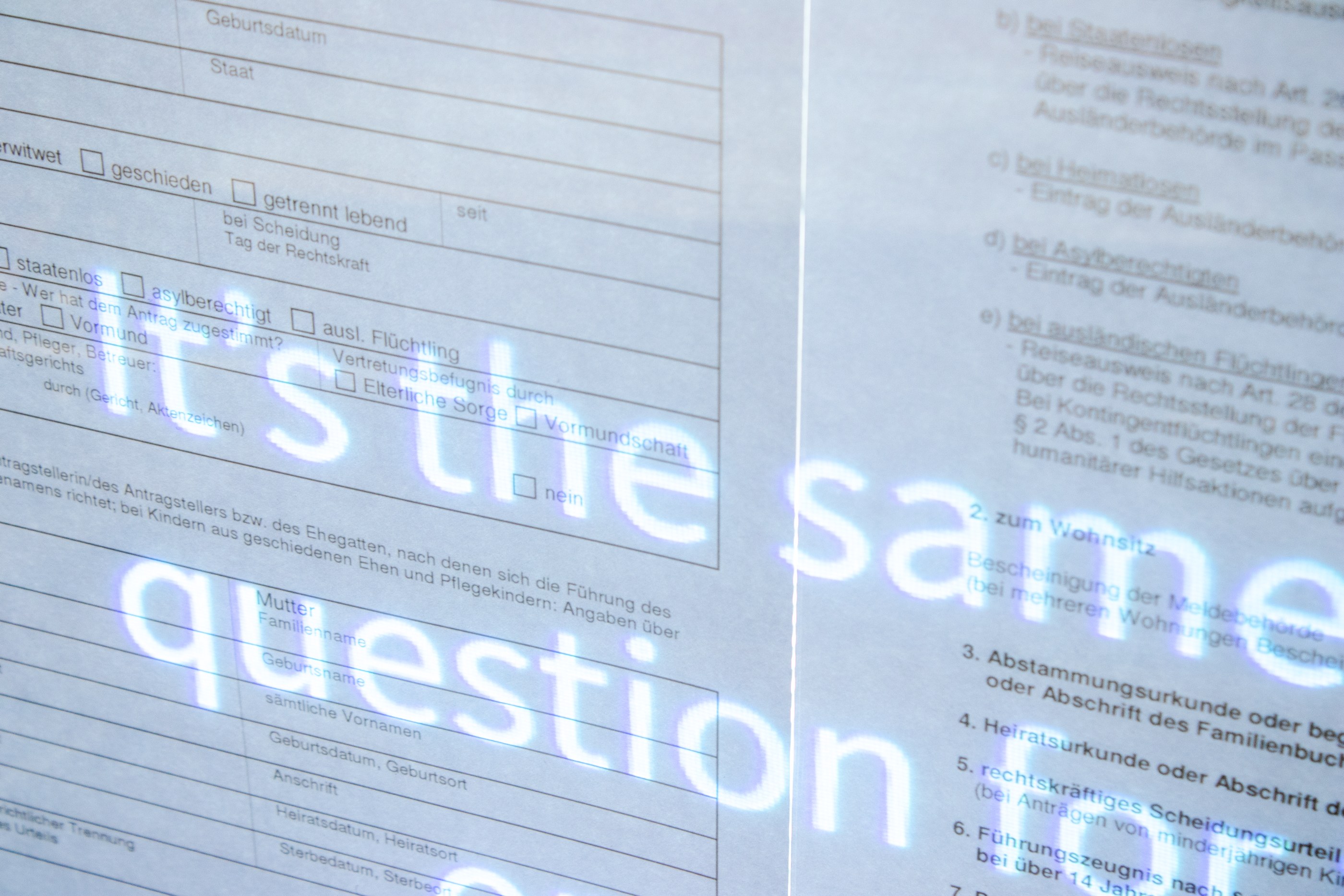 Close-up of a panel showing the video text projected through a german formular.