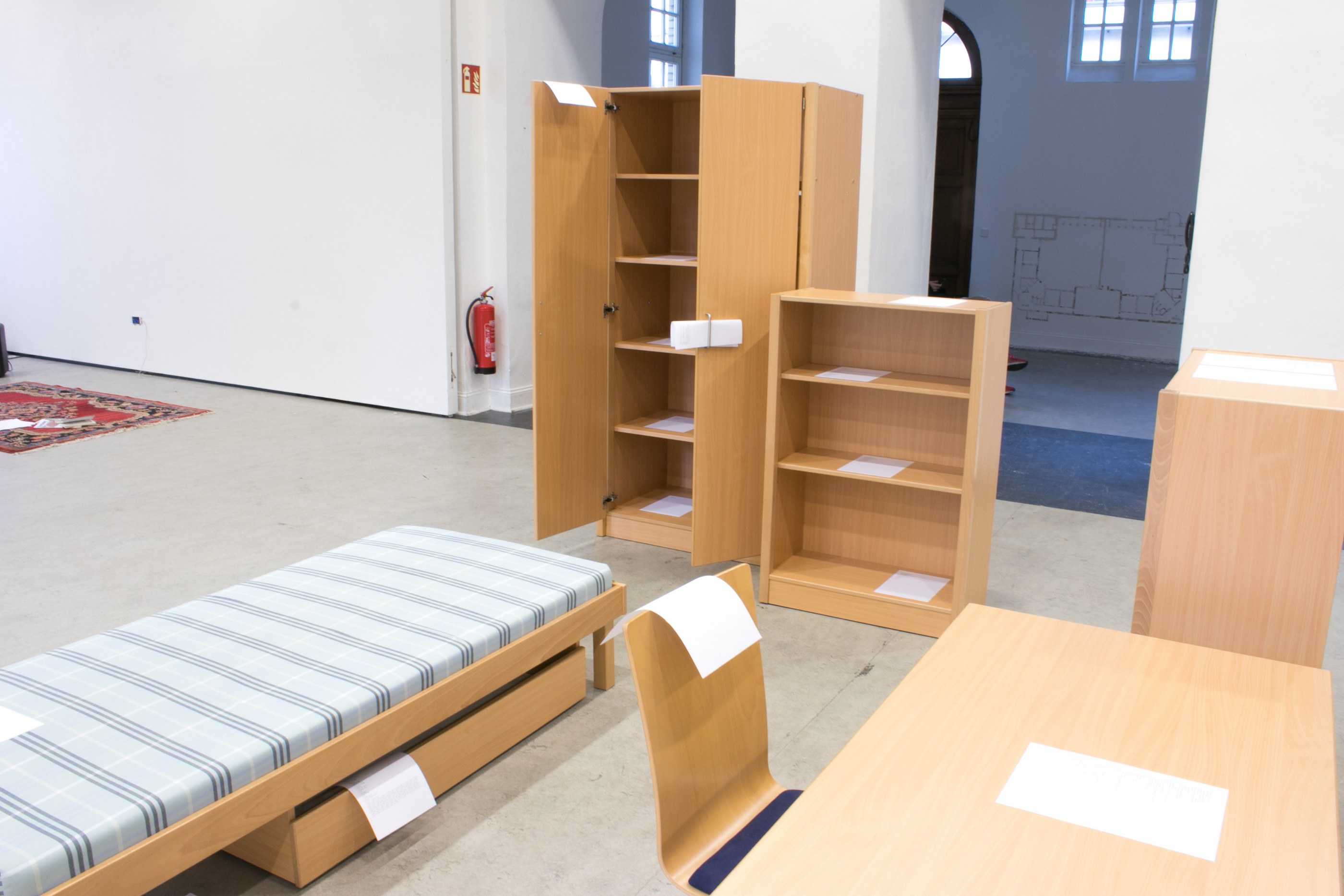 A closer view shows a number of A4 paper sheets placed on the furniture