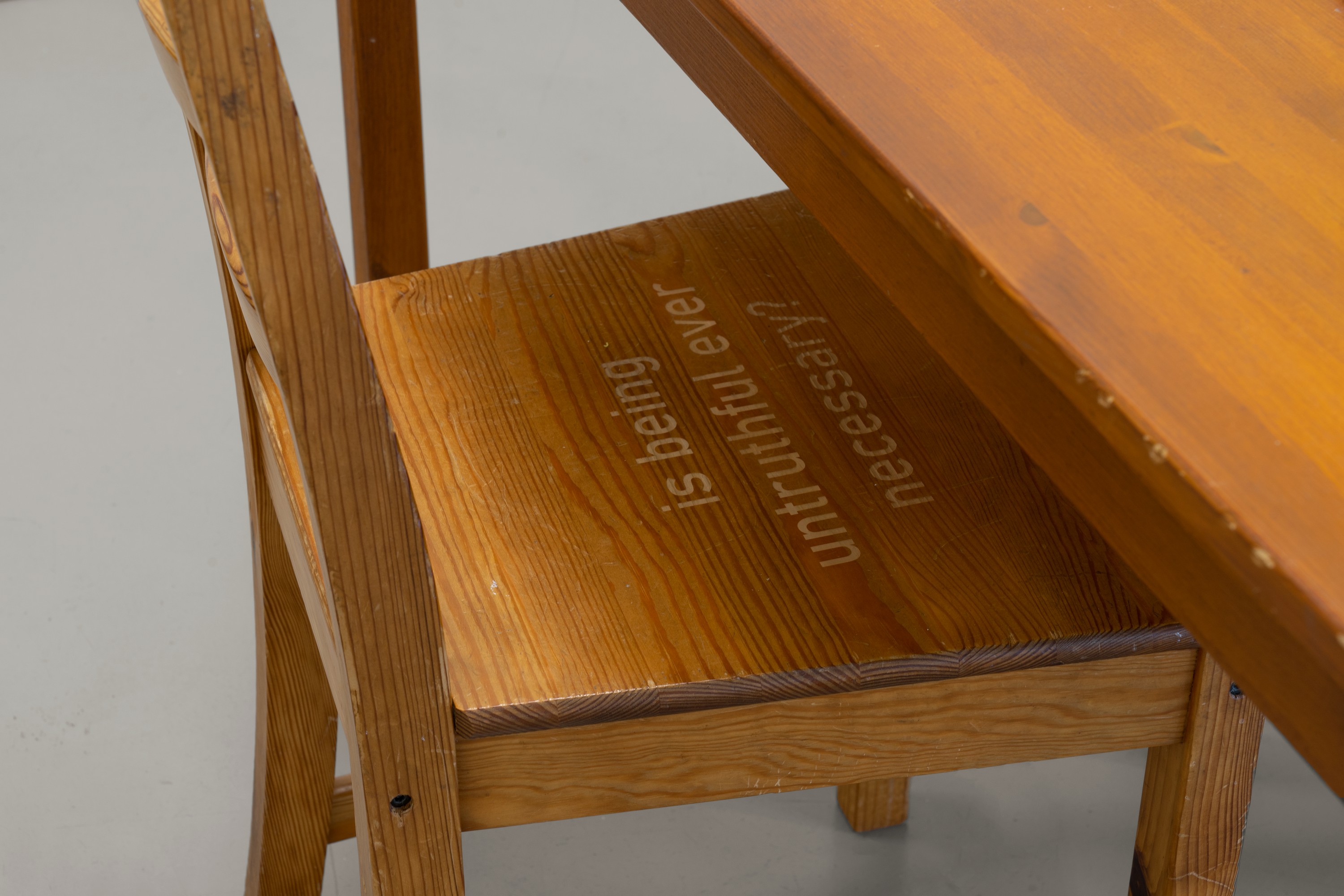 A chair with the seat engraved with the words, 