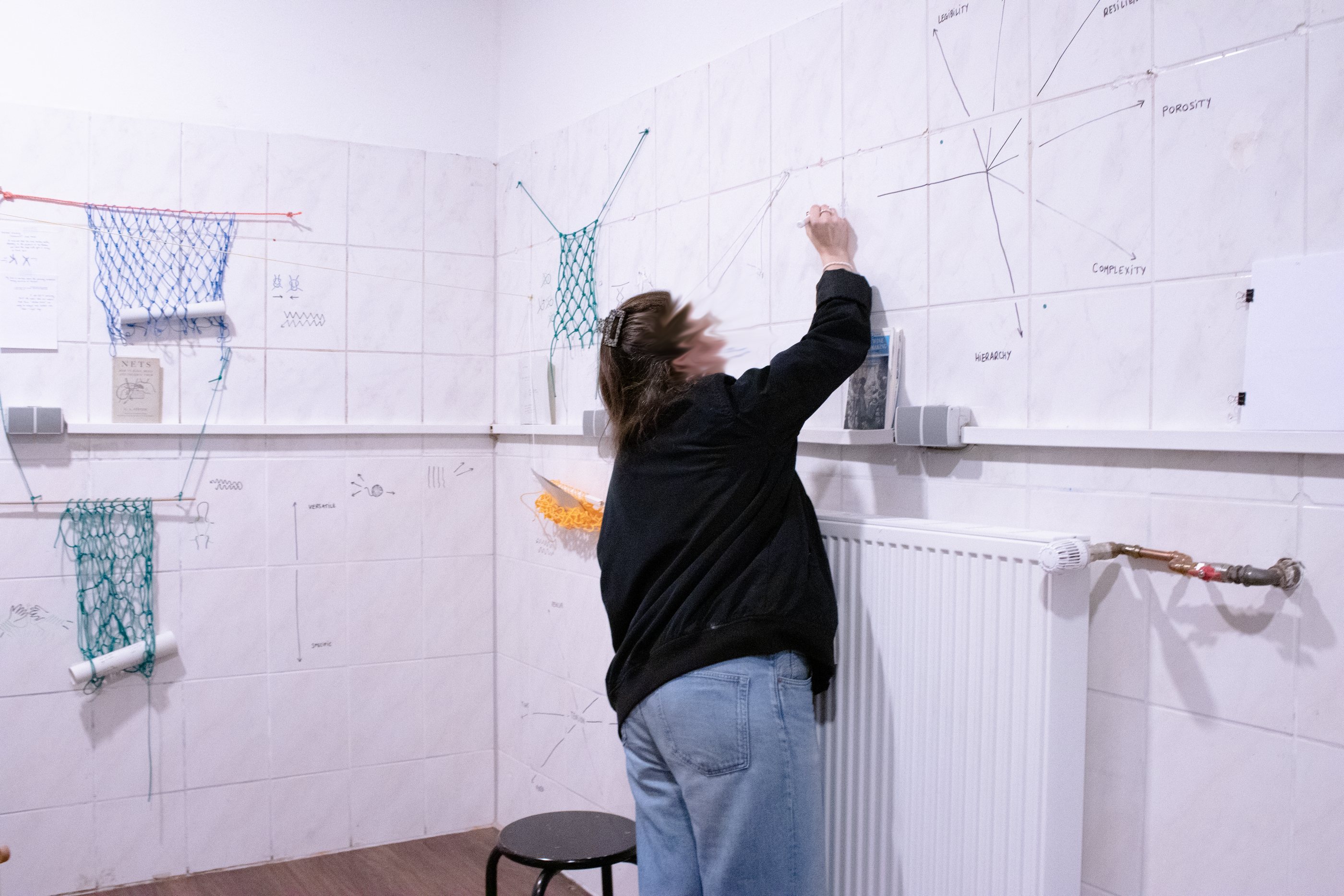 a person adding a comment to the installation wall